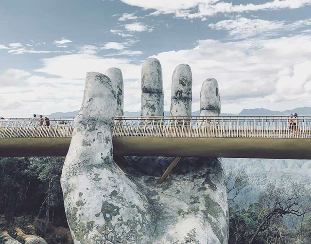 Hand supporting Golden Bridge - Golden Bridge